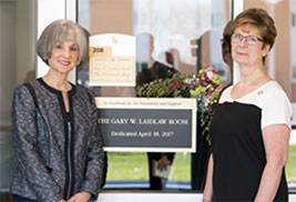 Camille Jayne standing in front of the Gary W. Laidlaw Room